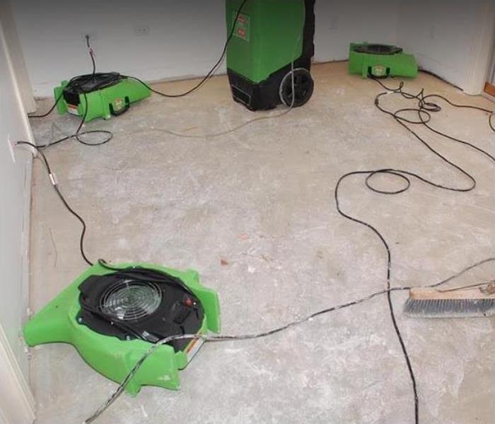 SERVPRO drying equipment setup on a concrete floor 