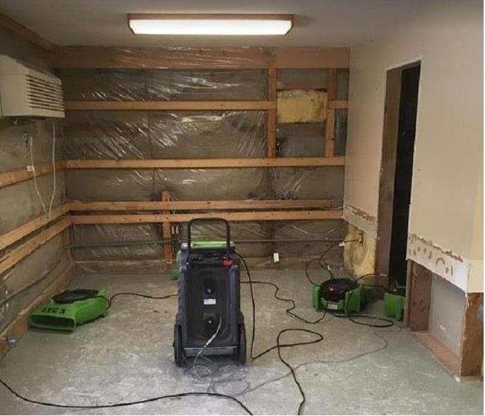 Water damaged room; flood cuts and drywall removed; SERVPRO drying equipment being used in room