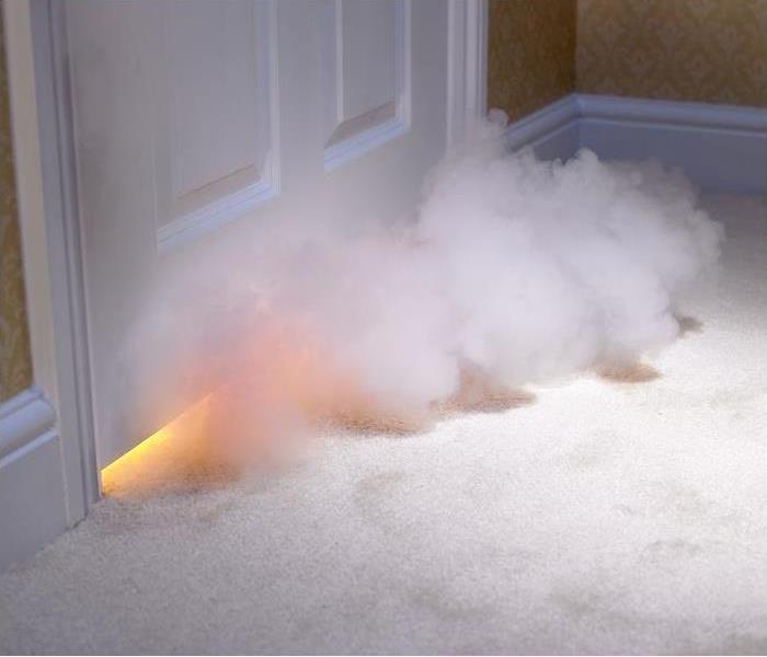 Smoke entering room under door; flames seen under door