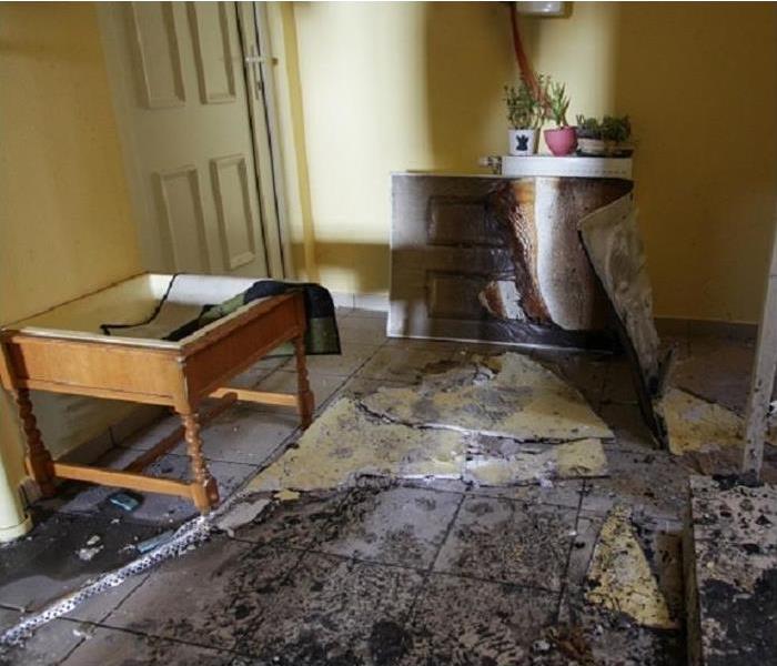 Fire damaged foyer; soot on floor smoke damage on home